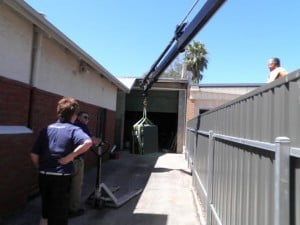 Using a crane to load a safe into one of Clarke Locksmiths vans for transportation at Clarke Locksmiths warehouse and showroom, The Parade, Norwood, South Australia S.A.5067